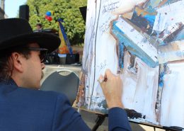 Band Member signing painting of piano